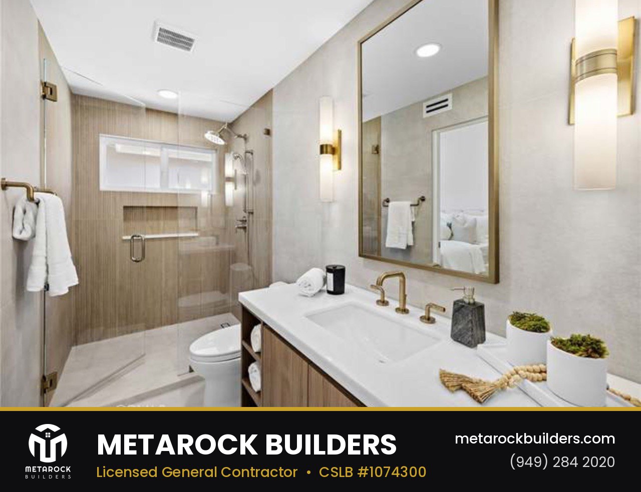 Bathroom remodel in Orange County by Sunward Builders Inc., completed after photo with wood-look tile shower, floating oak vanity, brushed brass fixtures, and framed mirror