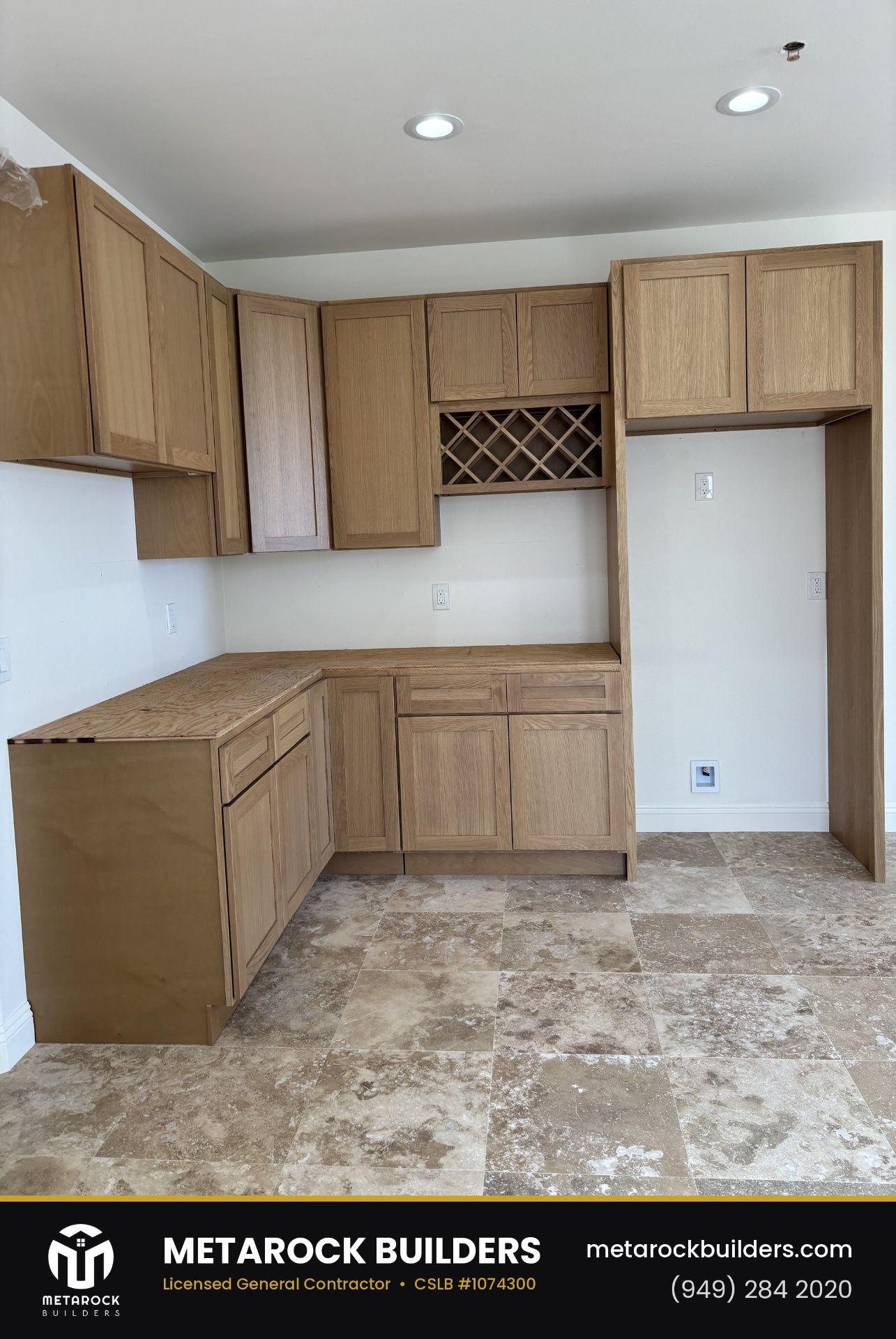 Kitchen remodel in Orange County by Sunward Builders Inc., completed after photo with natural oak shaker cabinetry, wine lattice, and travertine tile floor