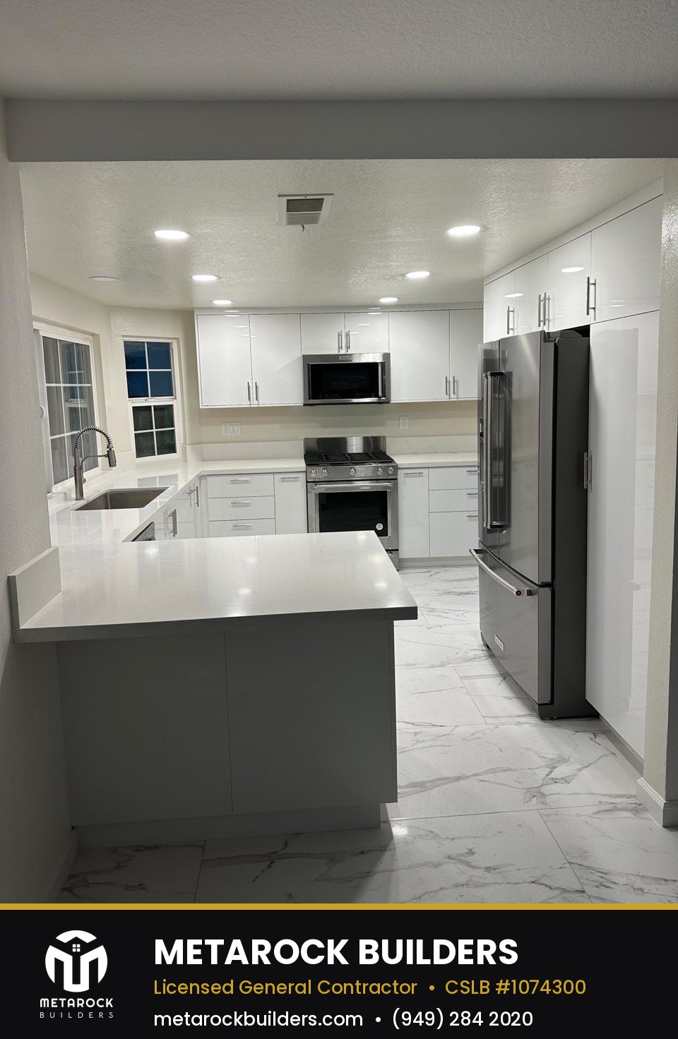 Kitchen remodel in Orange County by Sunward Builders Inc., completed after photo with white cabinetry, quartz counters, and marble-look tile floor