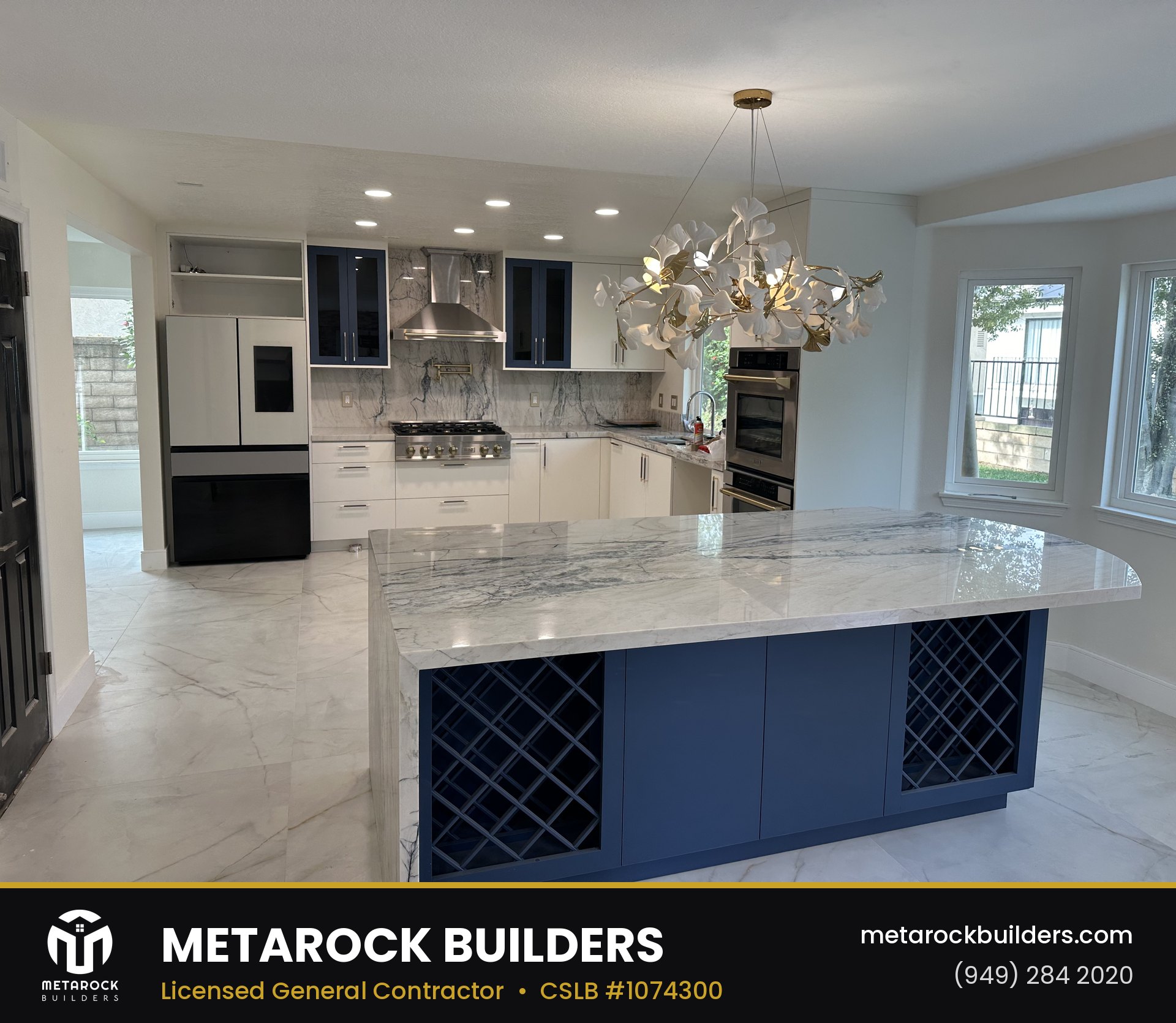 Kitchen remodel in Orange County by Sunward Builders Inc., completed after photo with marble island and navy cabinetry