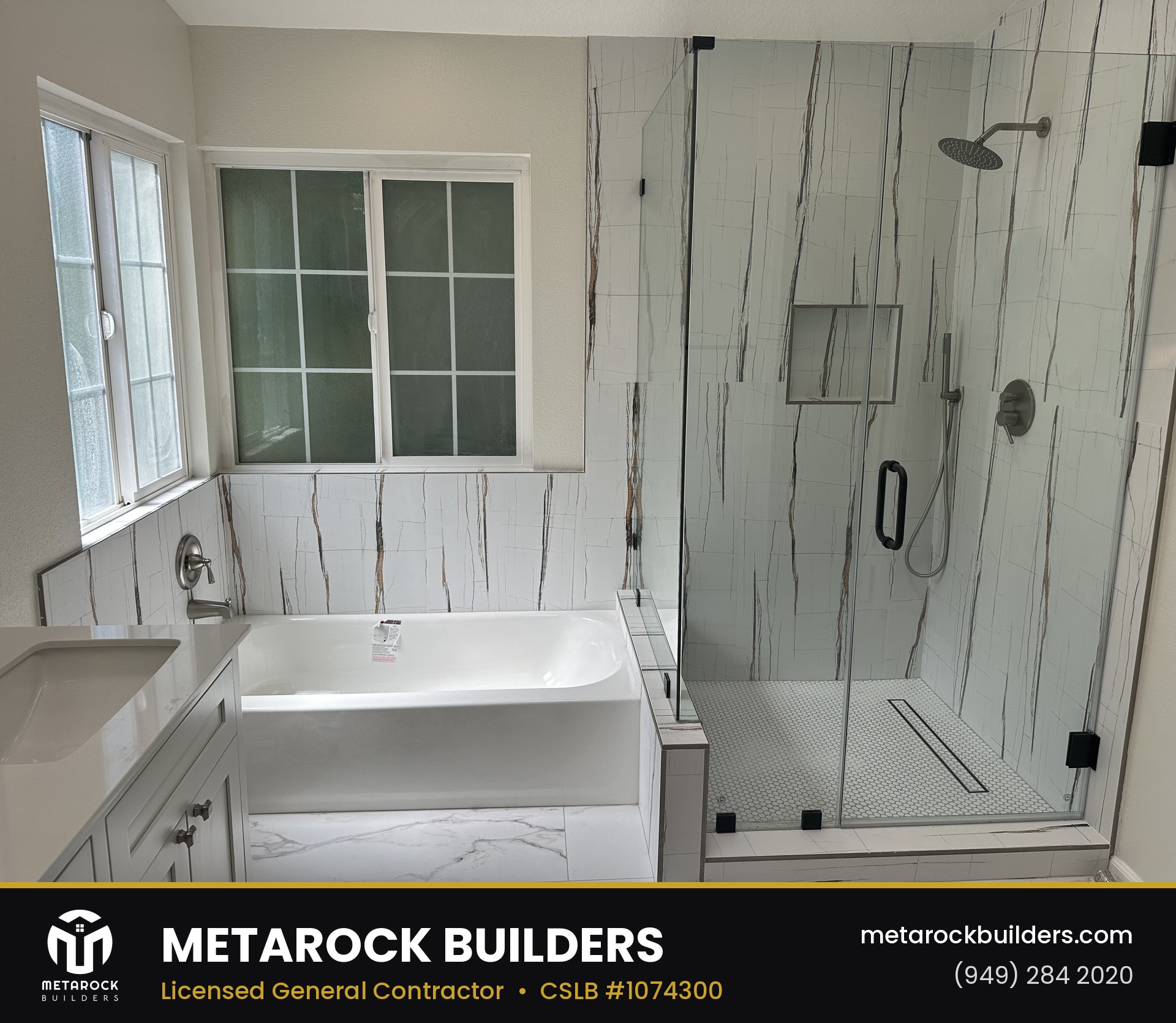 Bathroom remodel in Orange County by Sunward Builders Inc., completed after photo with veined marble-look tile, dual-sink shaker vanity, and frameless glass shower