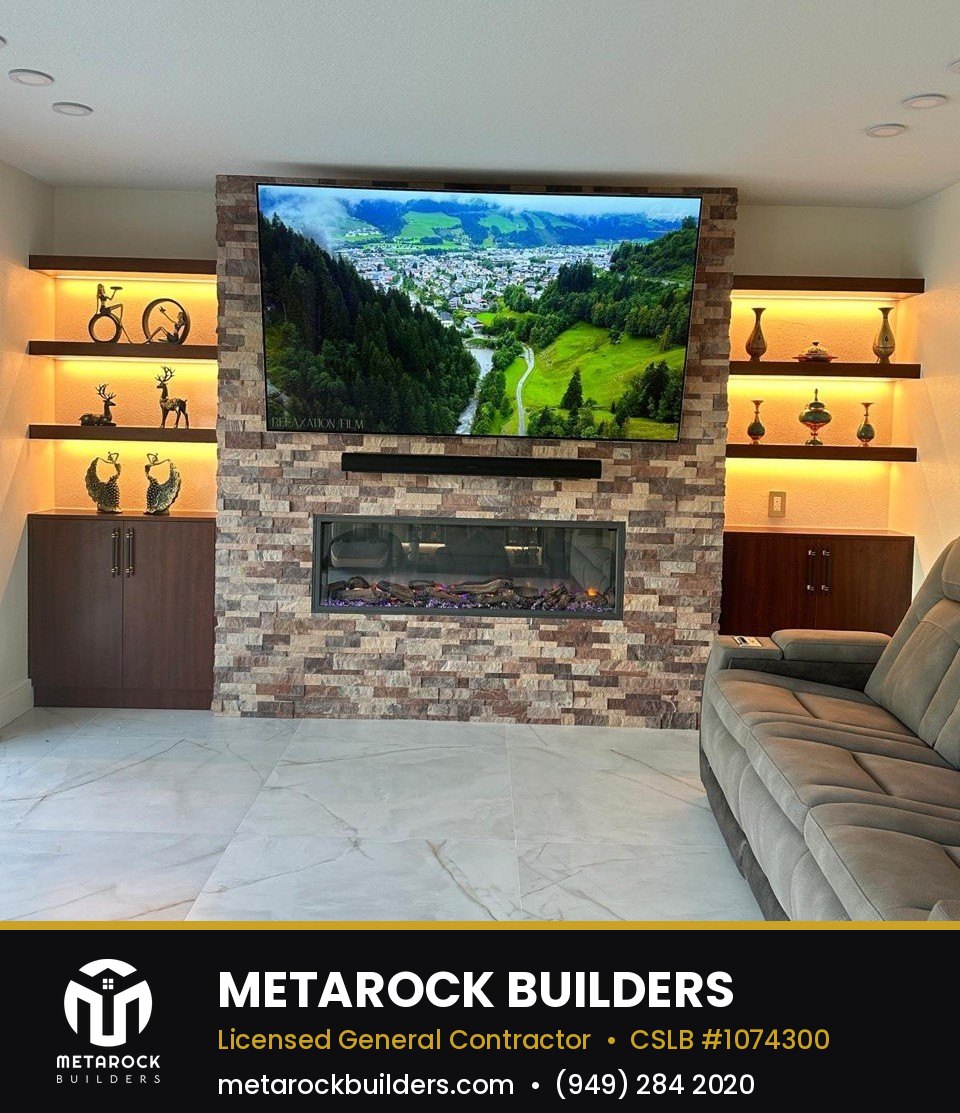 Fireplace remodel in Orange County by Sunward Builders Inc., completed after photo with stacked stone surround, floating walnut shelves, and linear electric fireplace
